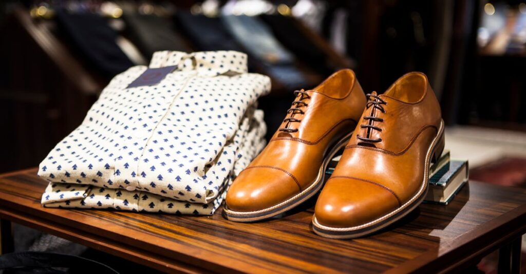 Elegant brown leather shoes and printed shirt displayed on a wooden table in a stylish clothing store.